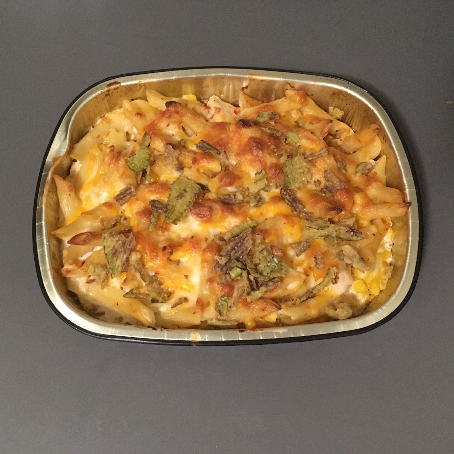 chipotle chicken alfredo baked penne topped with crispy jalapenos