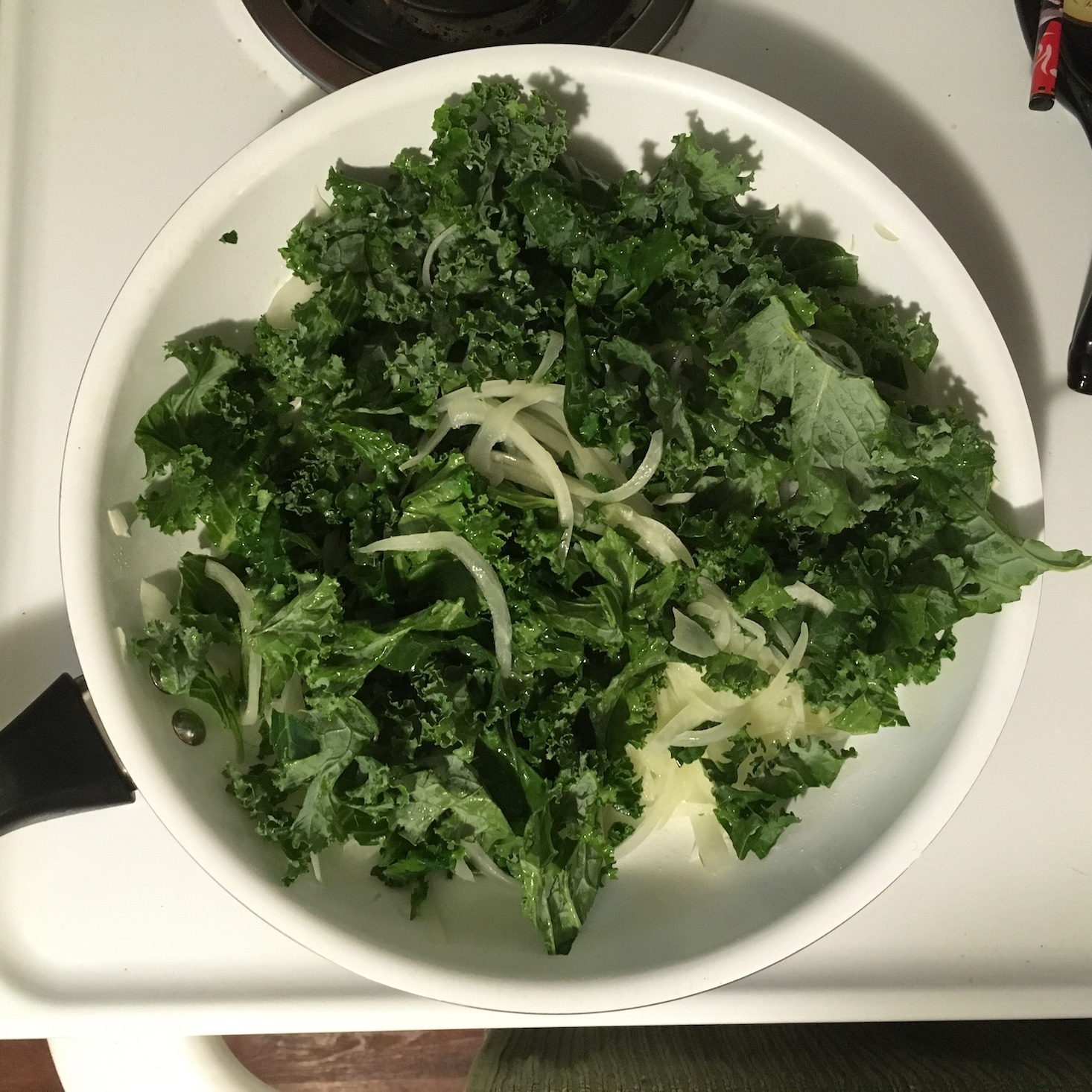 kale caesar flabtread onions and kale in the pan