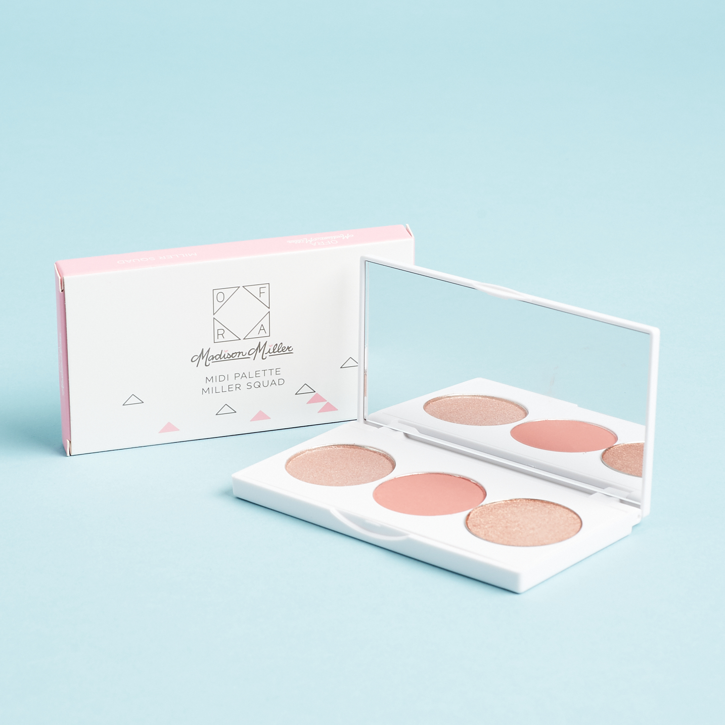 white palette with two highlighters and a blush in round pans