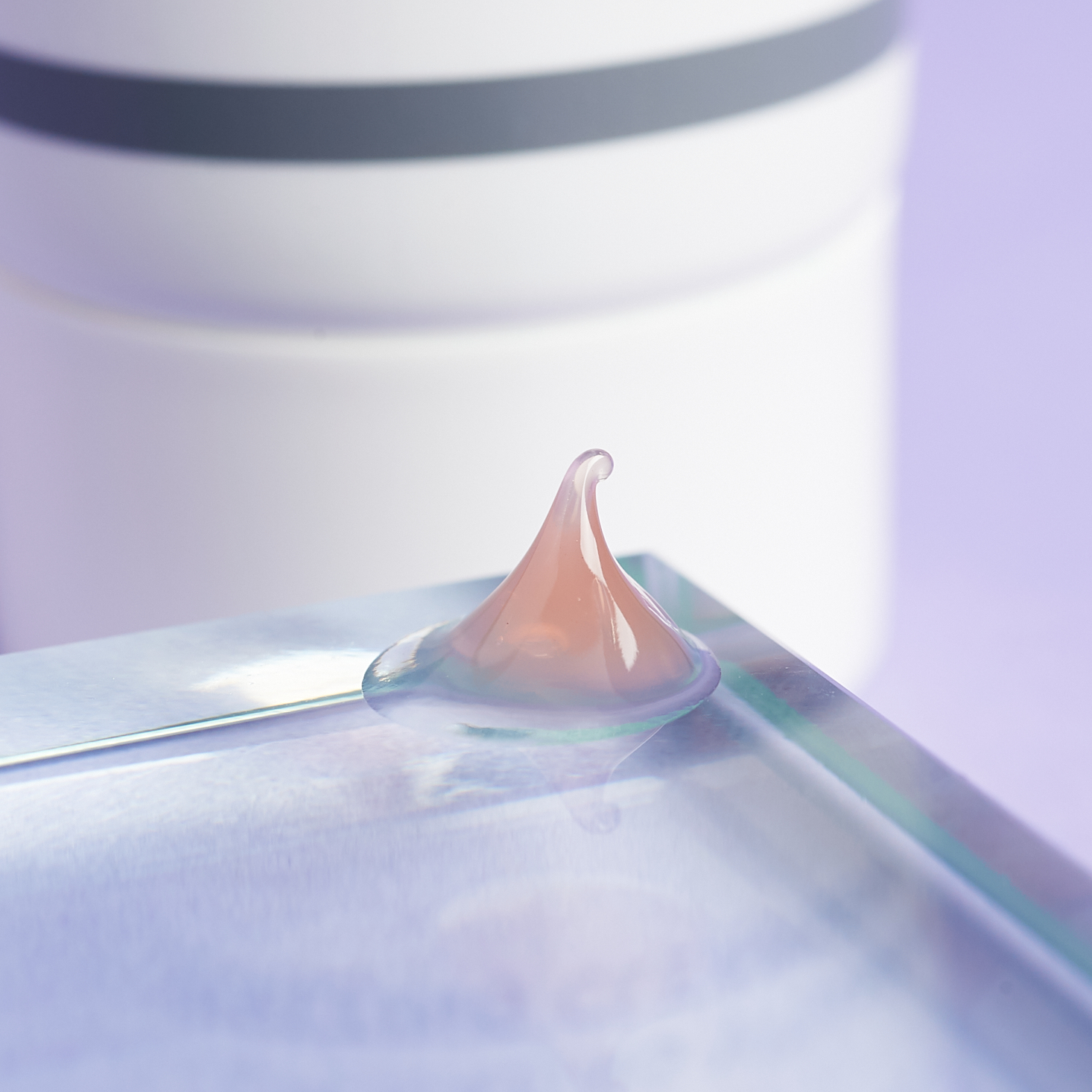 pink gel texture of cleanser on glass