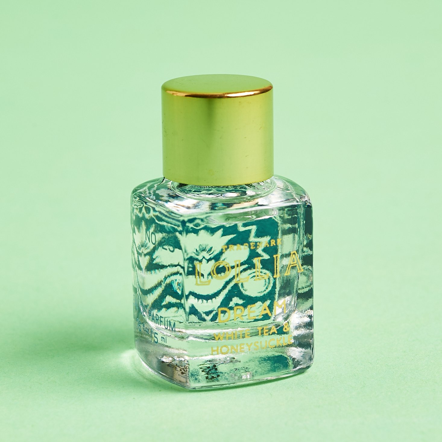 mini glass bottle of perfume with gold cap