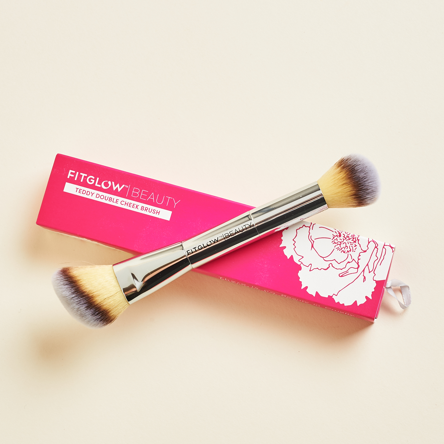 Fitglow Beauty Teddy Double Cheek Brush resting on top of box