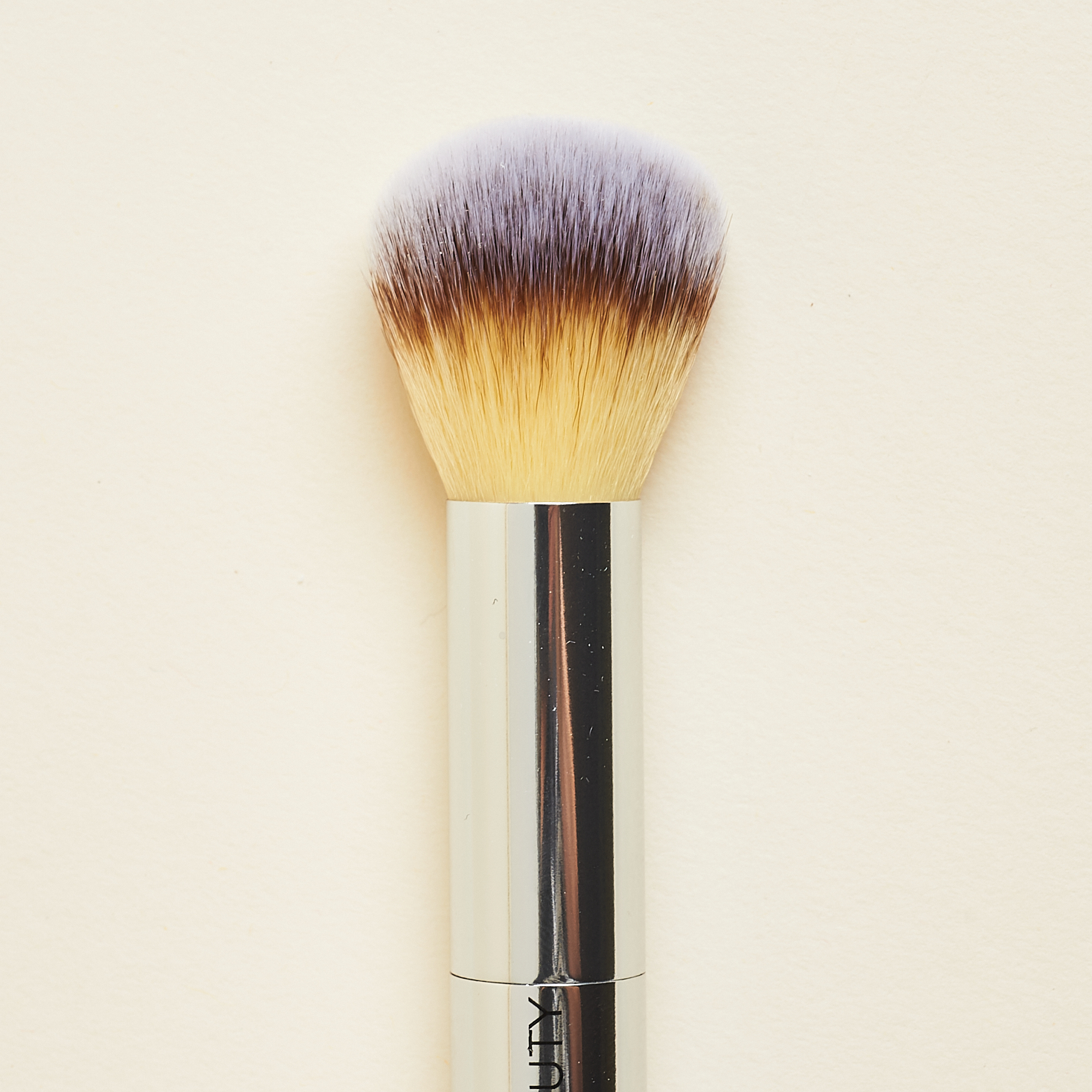 close up of rounded end of Fitglow Beauty Teddy Double Cheek Brush