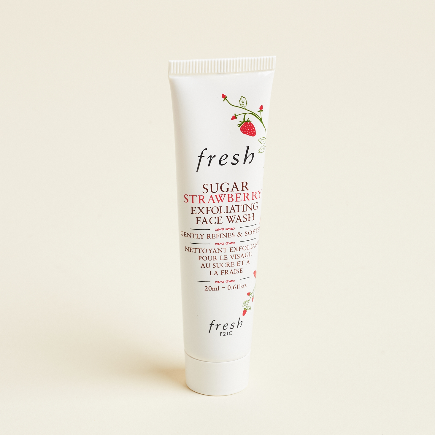 white tube of cleanser with text and strawberries on it