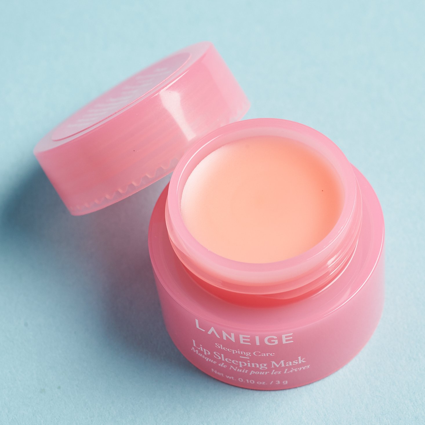 open LANEIGE Lip Sleeping Mask with lid resting on side