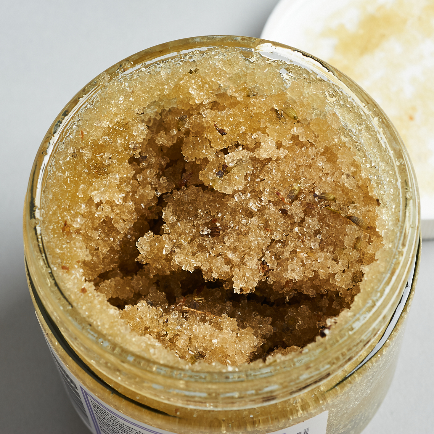 looking into open jar of Kosmatology Botanical Bliss Lavender Vanilla Sugar Body Scrub