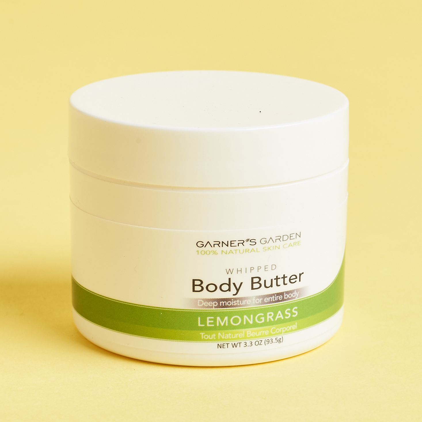 white tub of body butter with green label