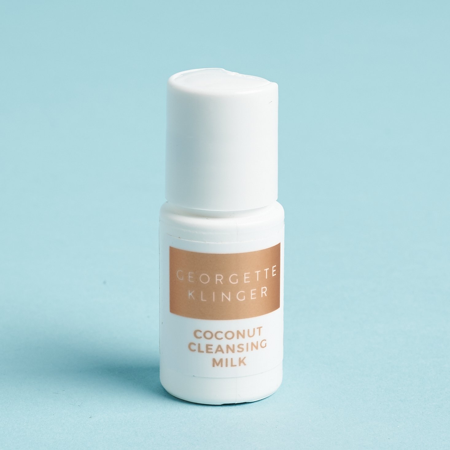 mini bottle of cleanser inwhite with rose gold label