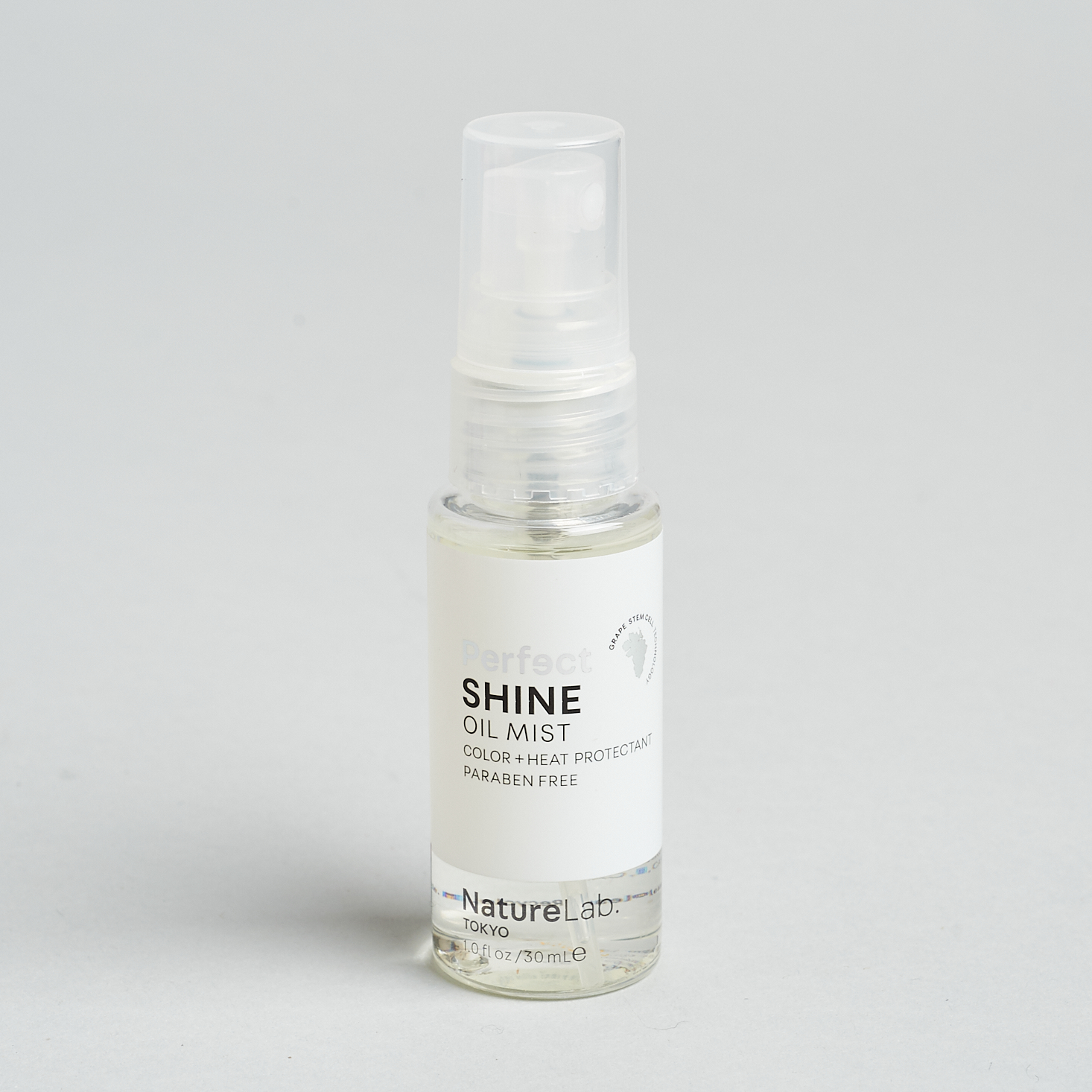 clear spray bottle of hair oil mist