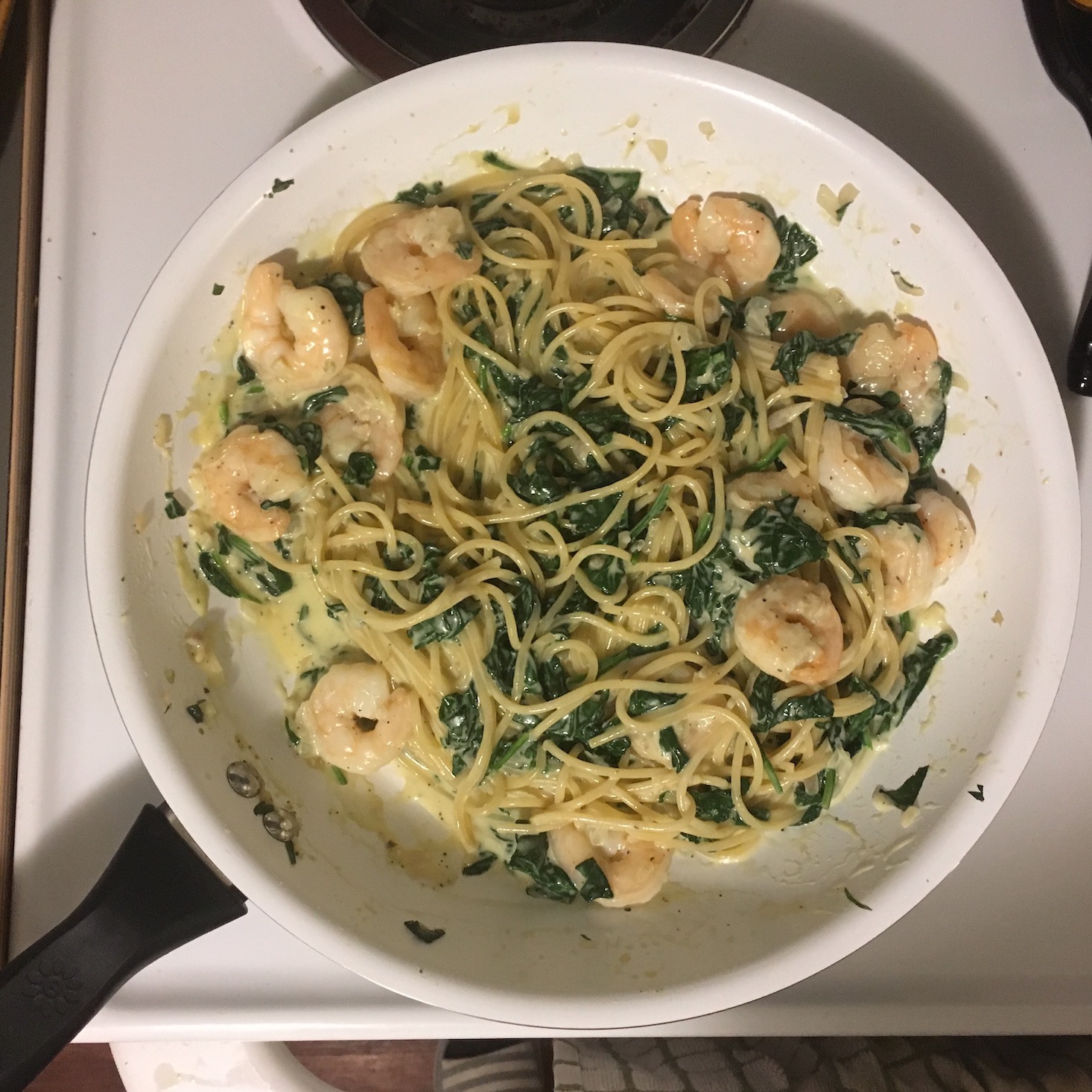 shrimp florentine in pan with spaghetti