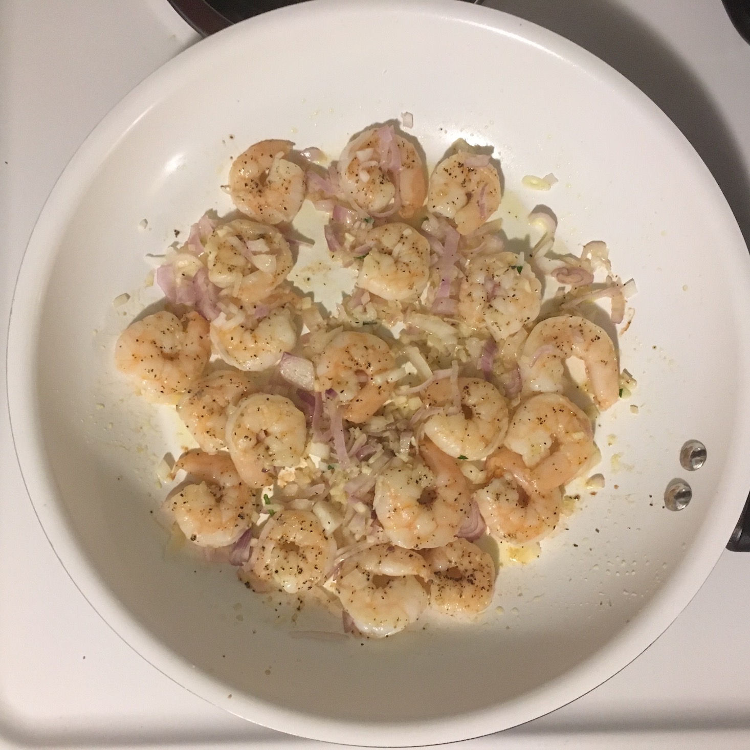 shrimp florentine shrimps in saute pan with shallots and garlic