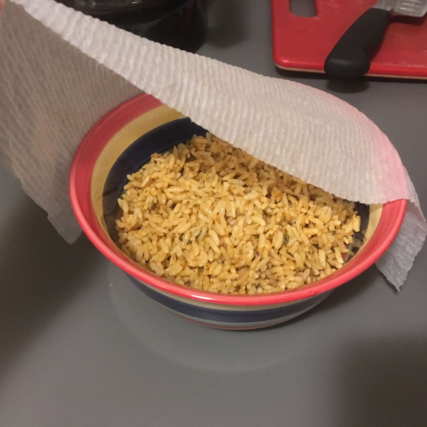 steak and rice bowls rice in bowl before microwave with a damp paper towel on top