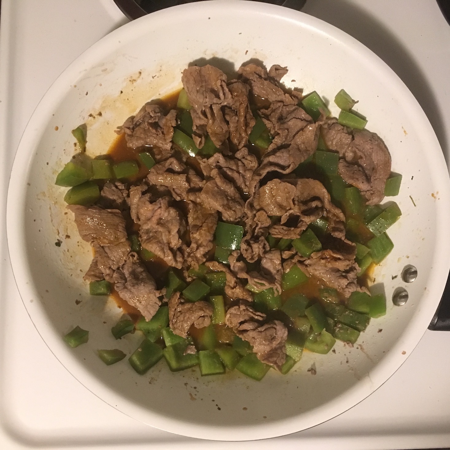 steak and rice bowls steak and peppers in pan with wine and demi glace