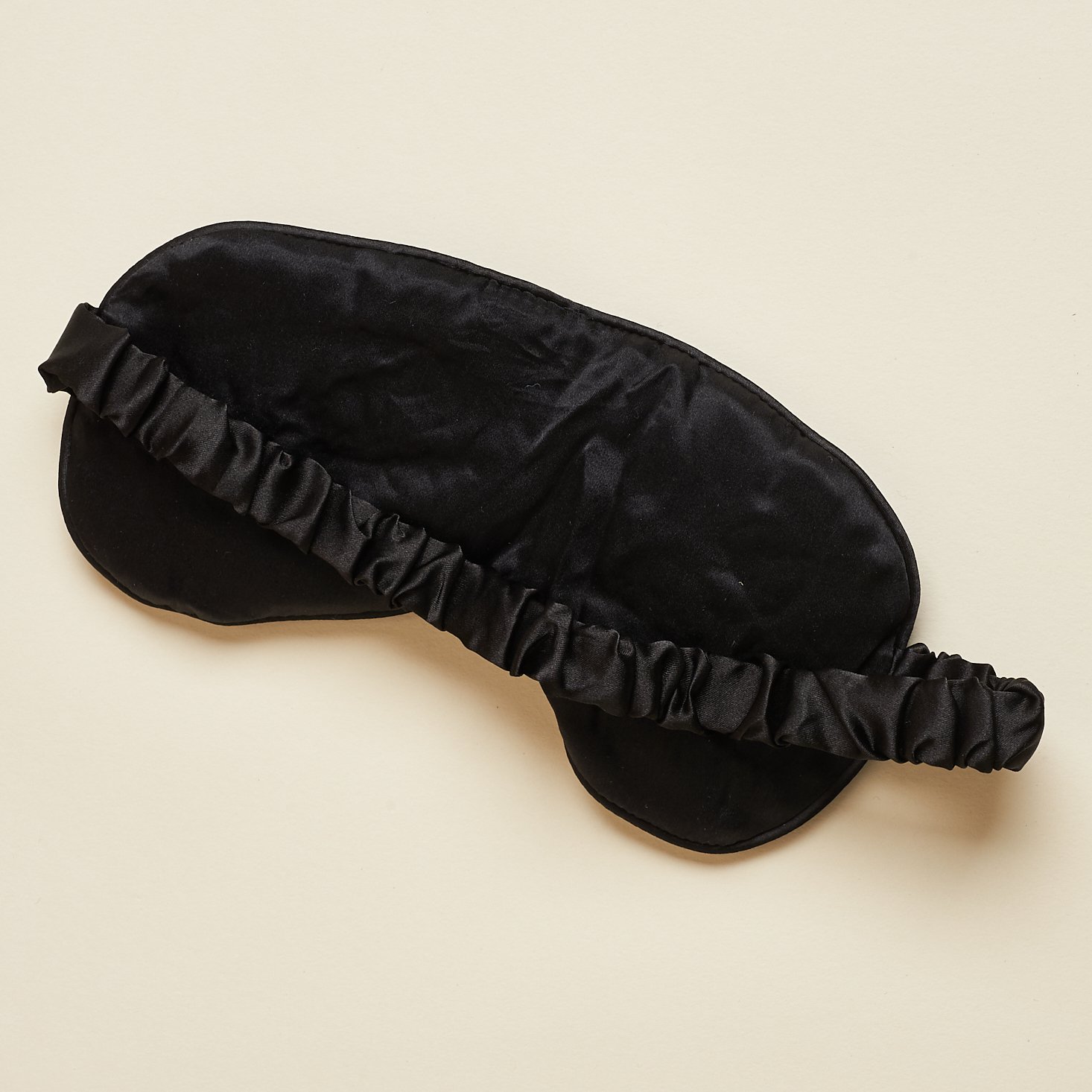 back side of black silk sleep mask