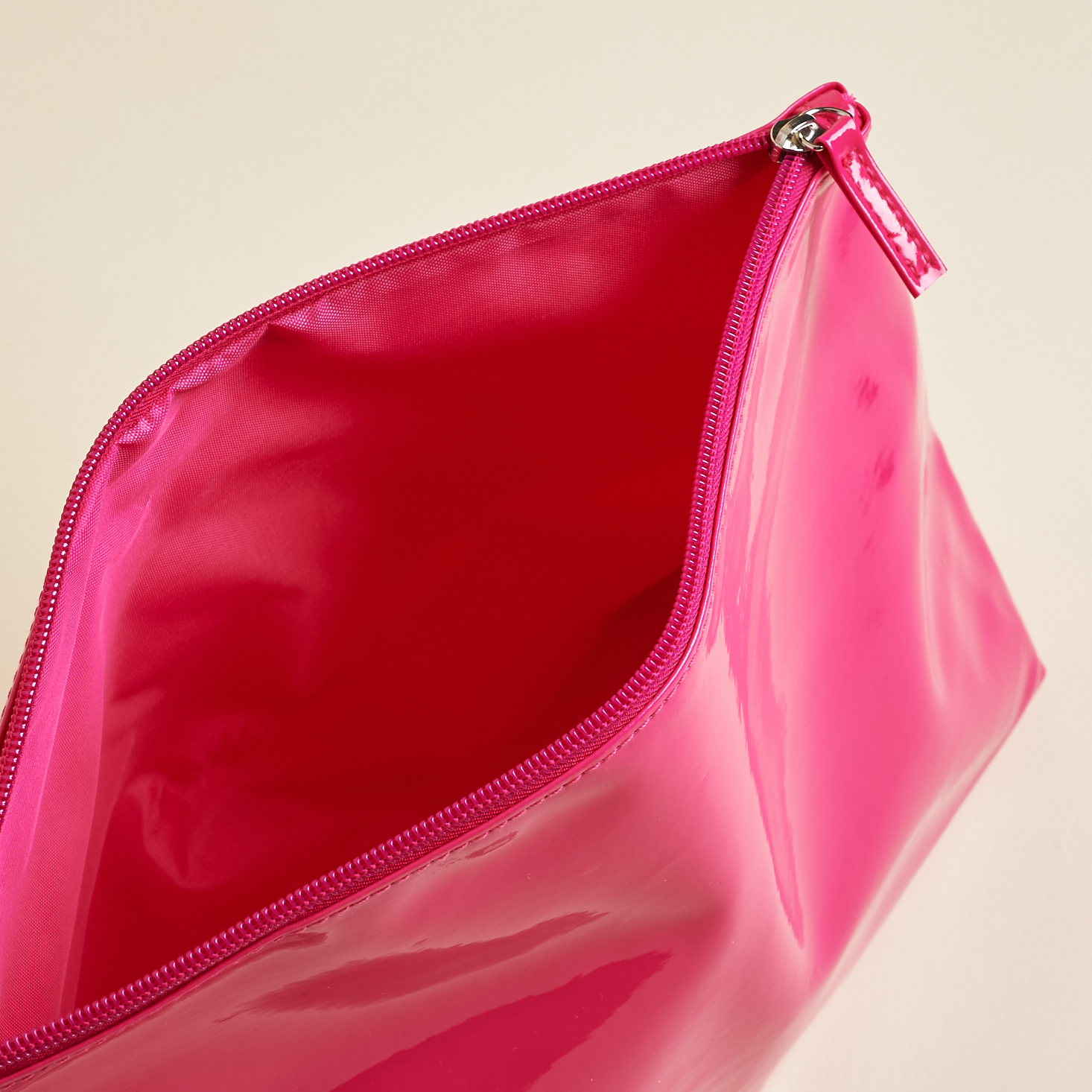 Pink makeup bag unzipped to show inside