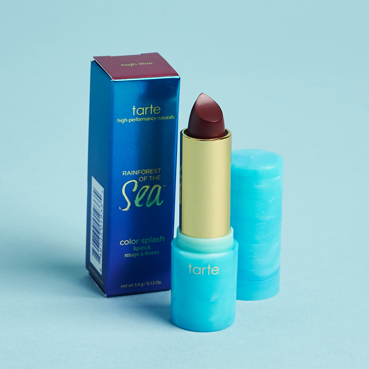 teal and gold tube of deep red lipstick