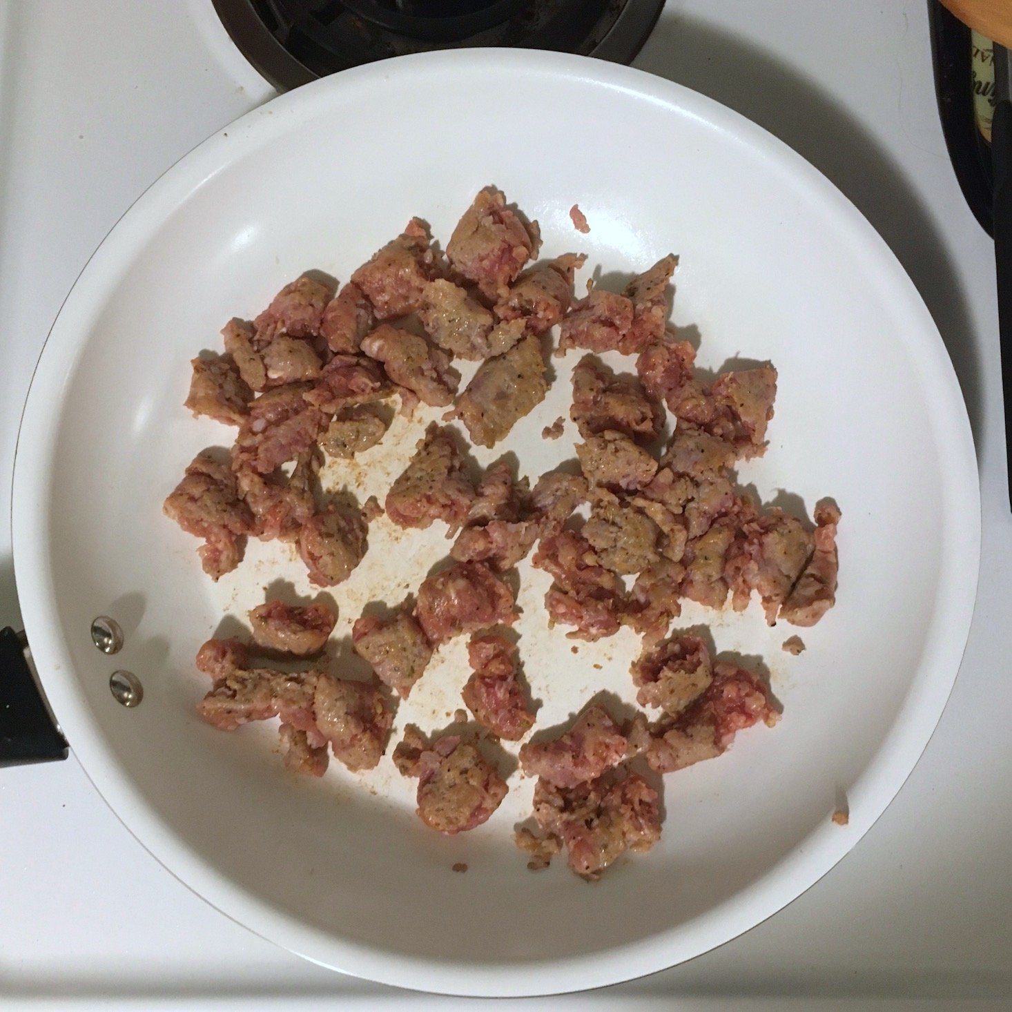 sausage cooking in pan