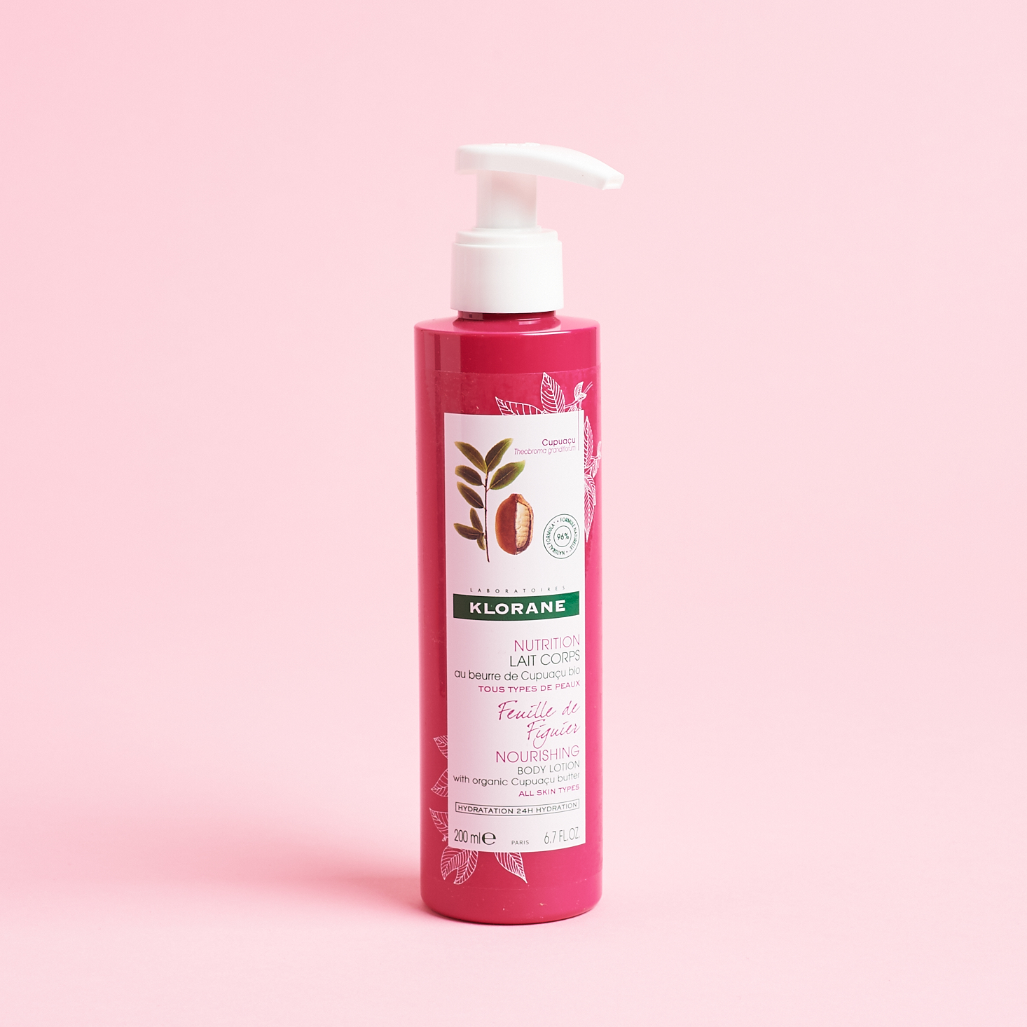 hot pink bottle of lotion with white pump