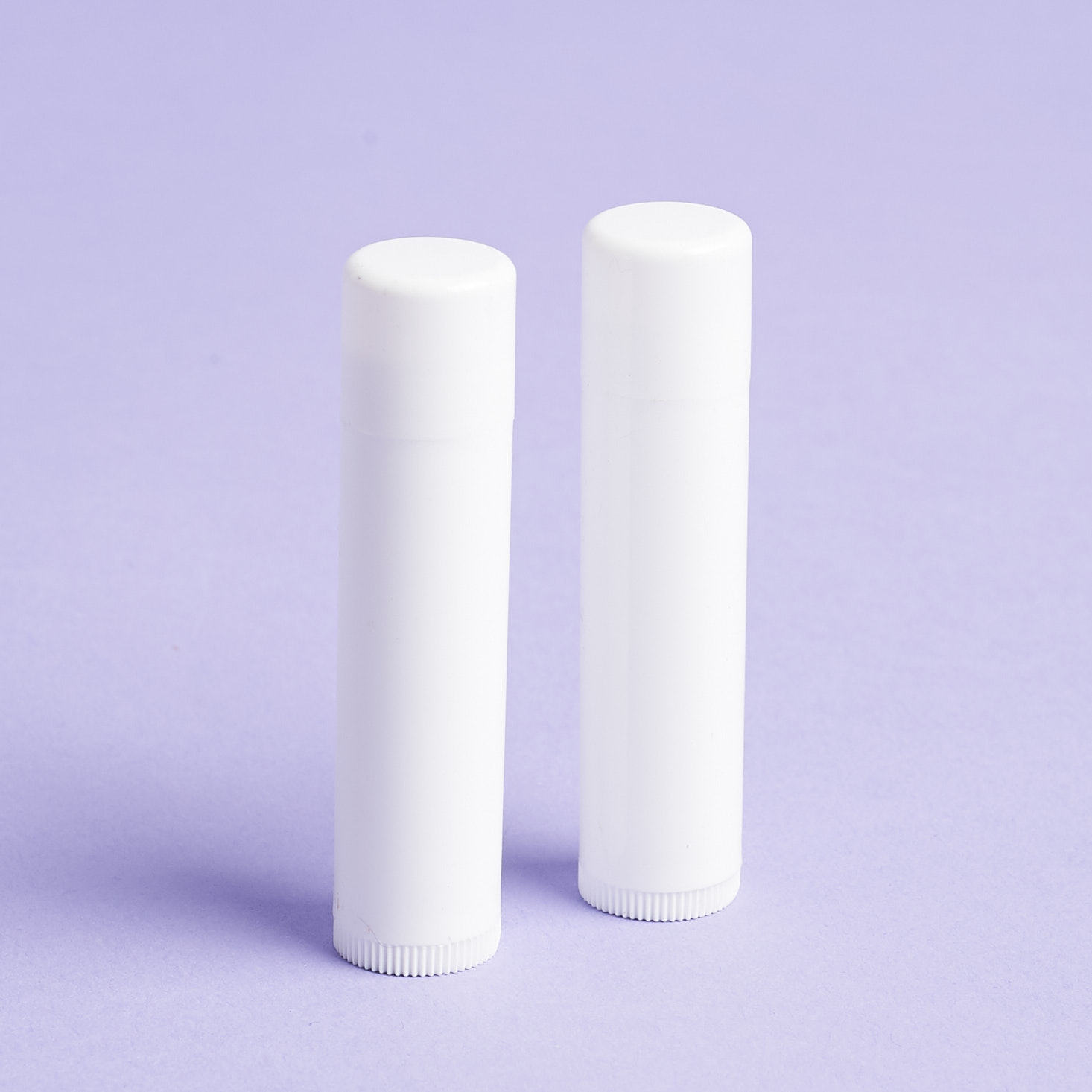 duo of empty white lip balm containers