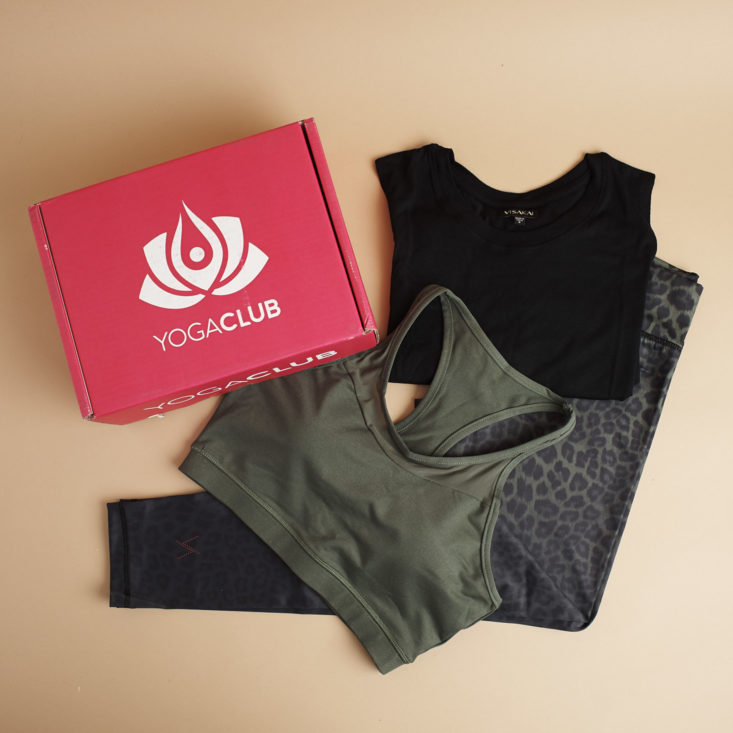 box and yoga clothes laying flat on a brown table