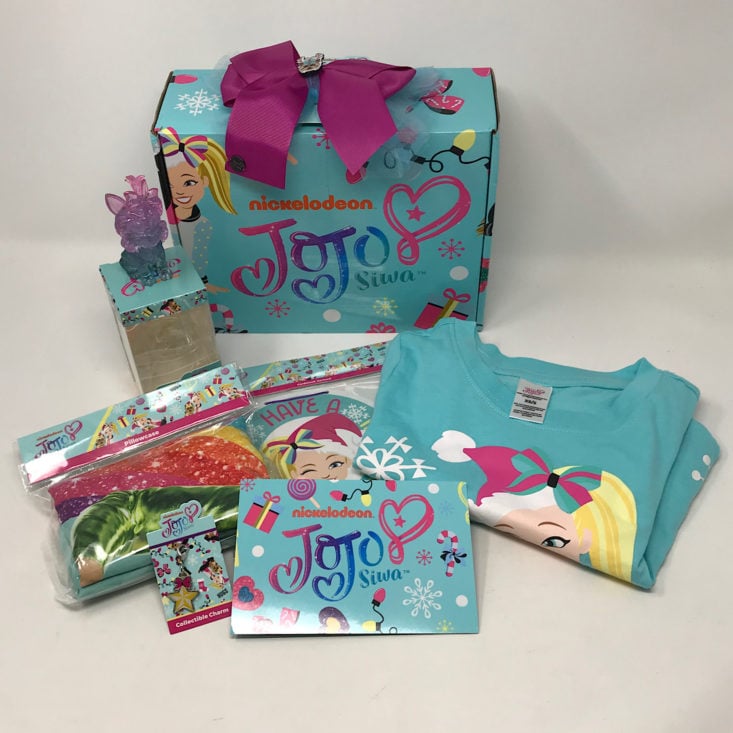 A collection of merchandise from the December 2019 Jojo Siwa Box.