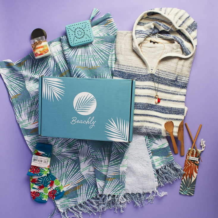 Beachly subscription featuring a boho hoodie, a candle, a towel, and other lifestyle items.