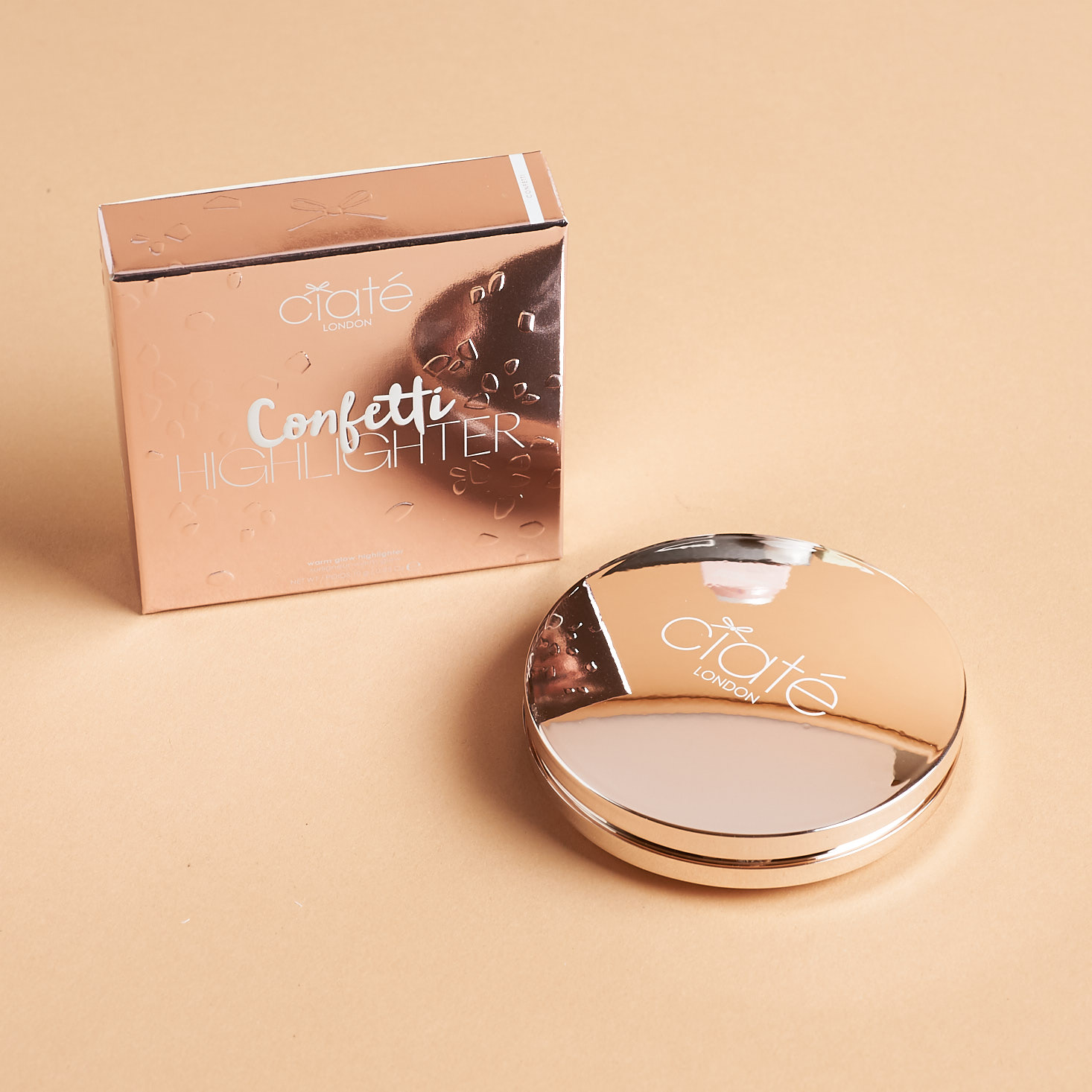metallic rose gold compact with confetti ptterned highlighter inside