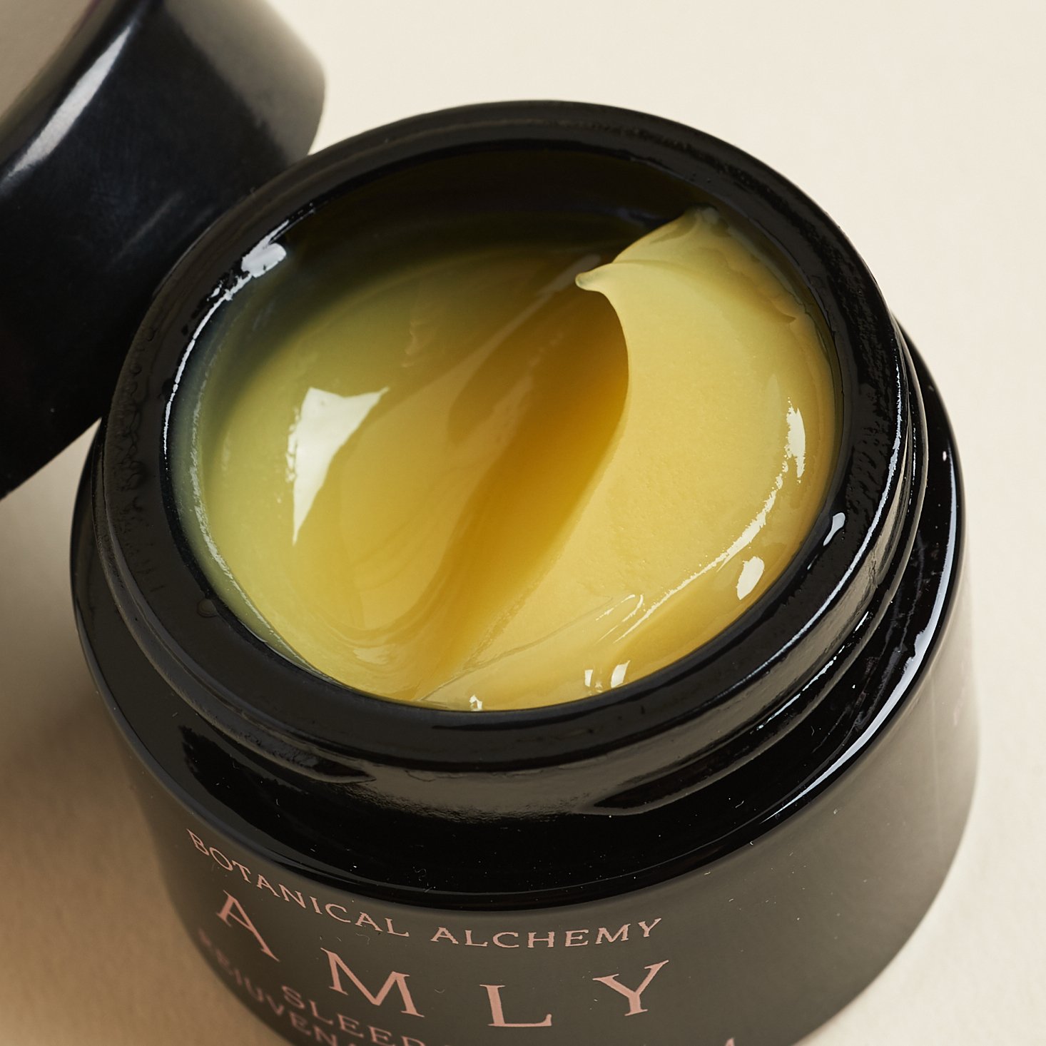 AMLY Sleep Tight Rejuvenating Face Balm, open with lid leaning on edge