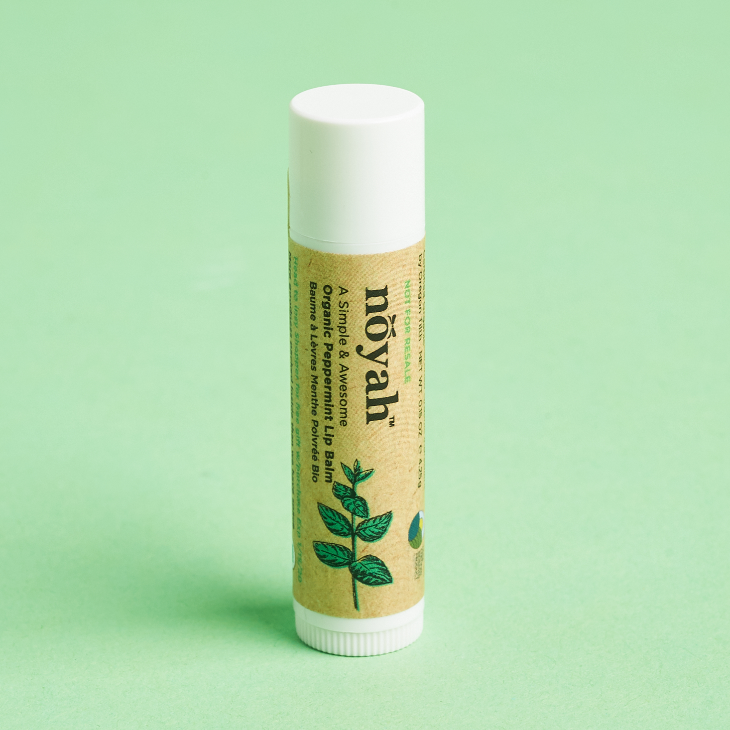 white tube lf lip balm ith brown labe.