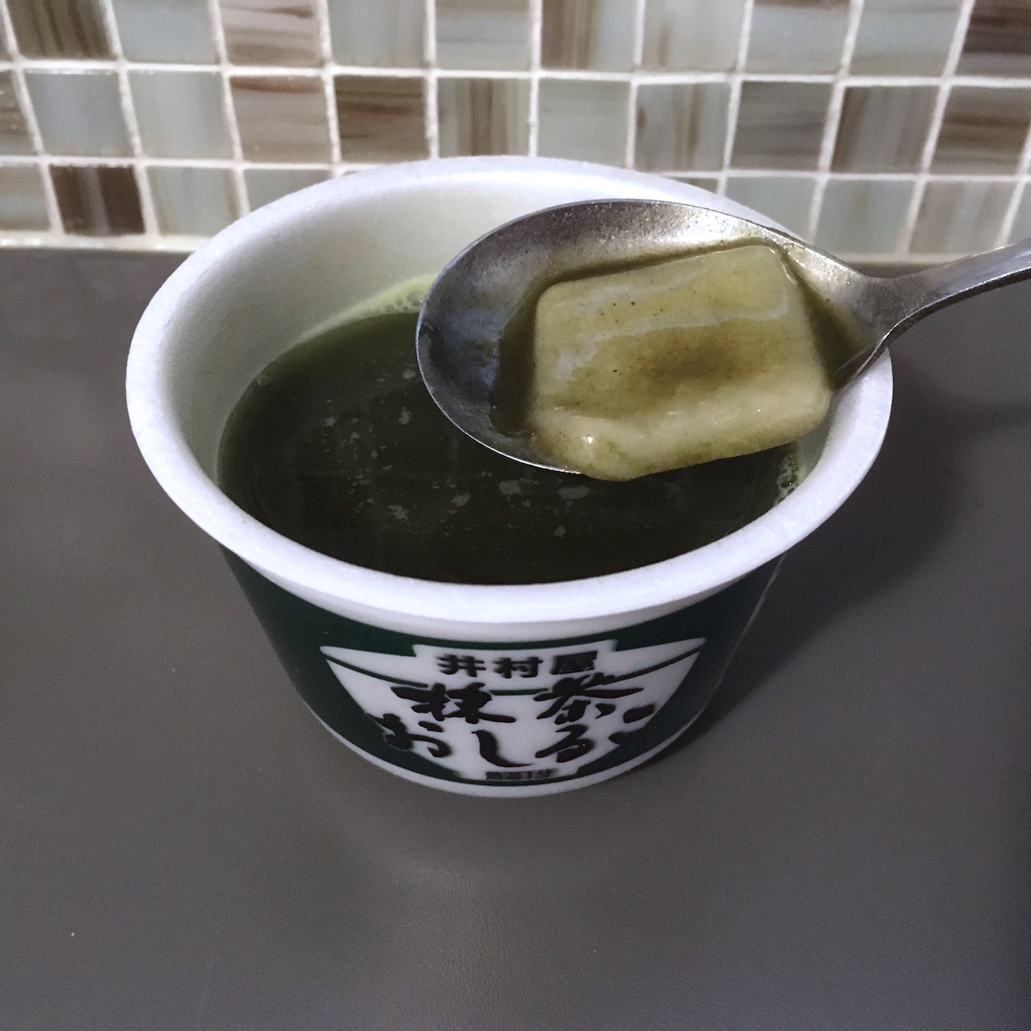 matcha mochi soup showing mochi on spoon