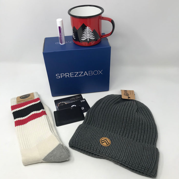 Men's accessories like a beanie, socks, and tin mug from the SprezzaBox monthly subscription.