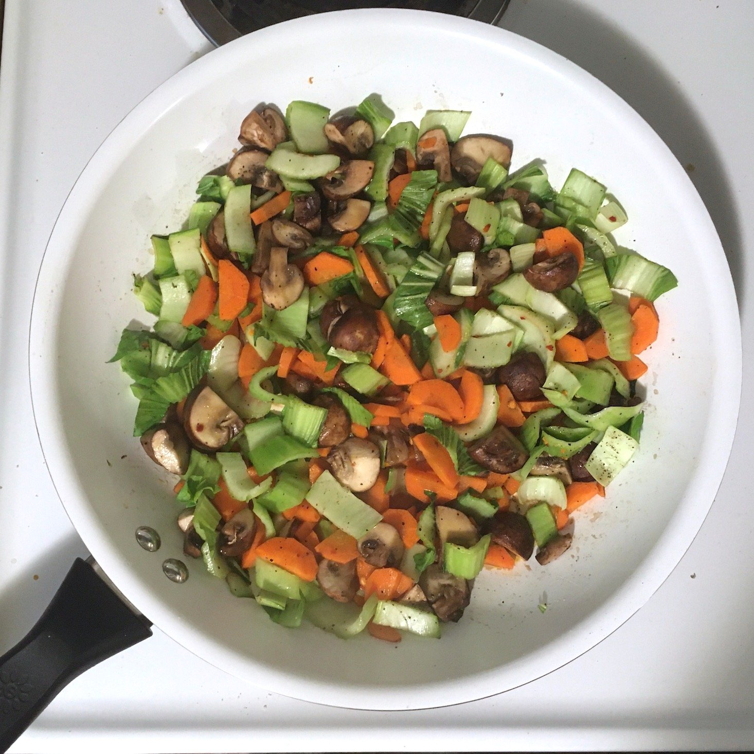 miso butter shrimp bok choy stems, carrots, and mushrooms in pan