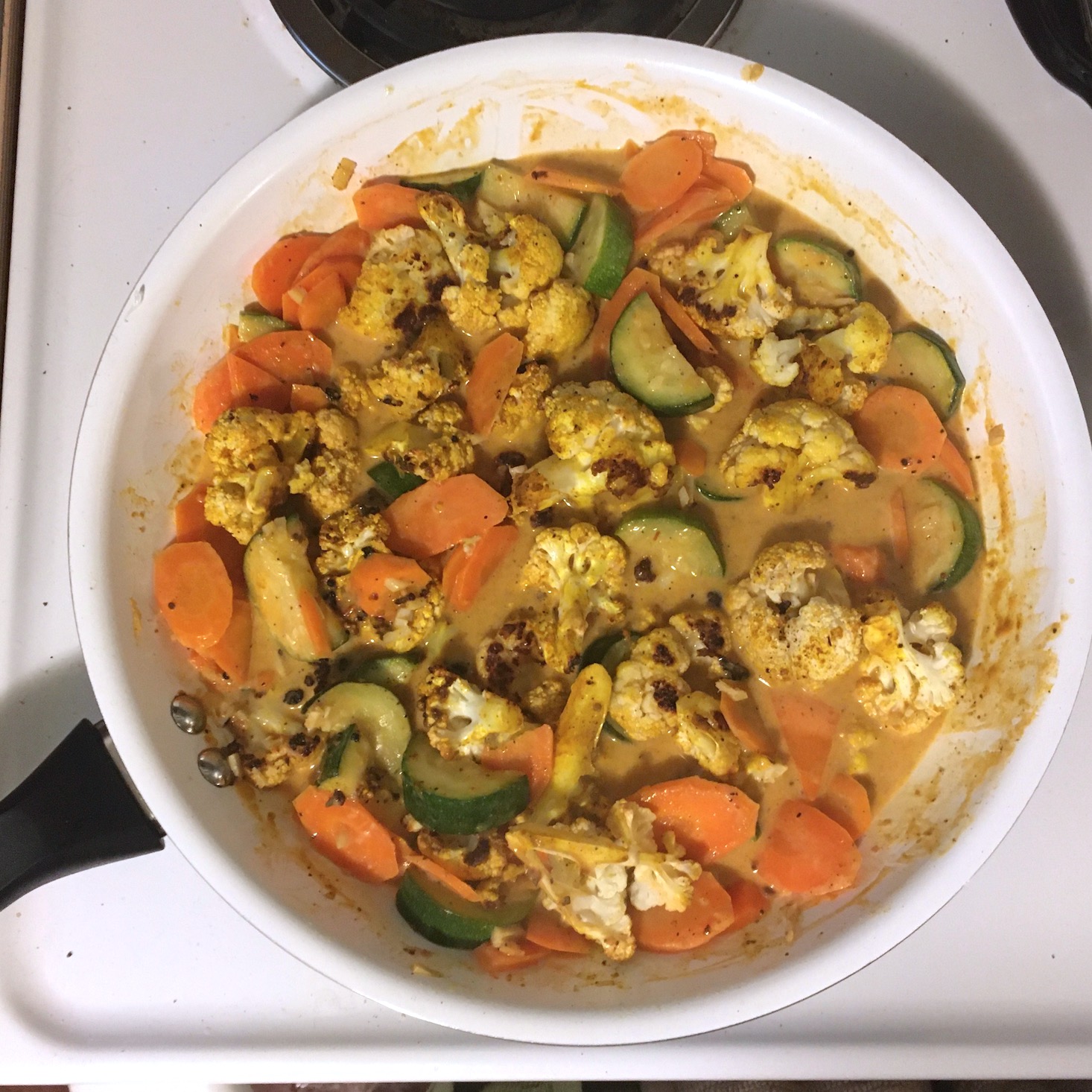 veggie curry cauliflower added to sauce and pan