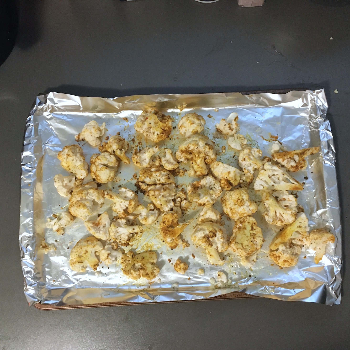 veggie curry roasted cauliflower on baking sheet