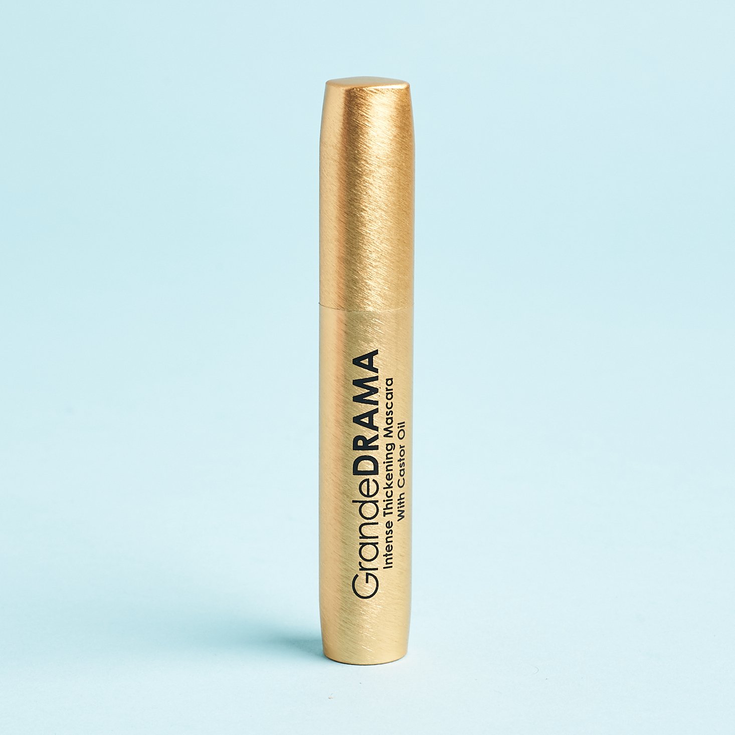 large gold mascara tube with black text