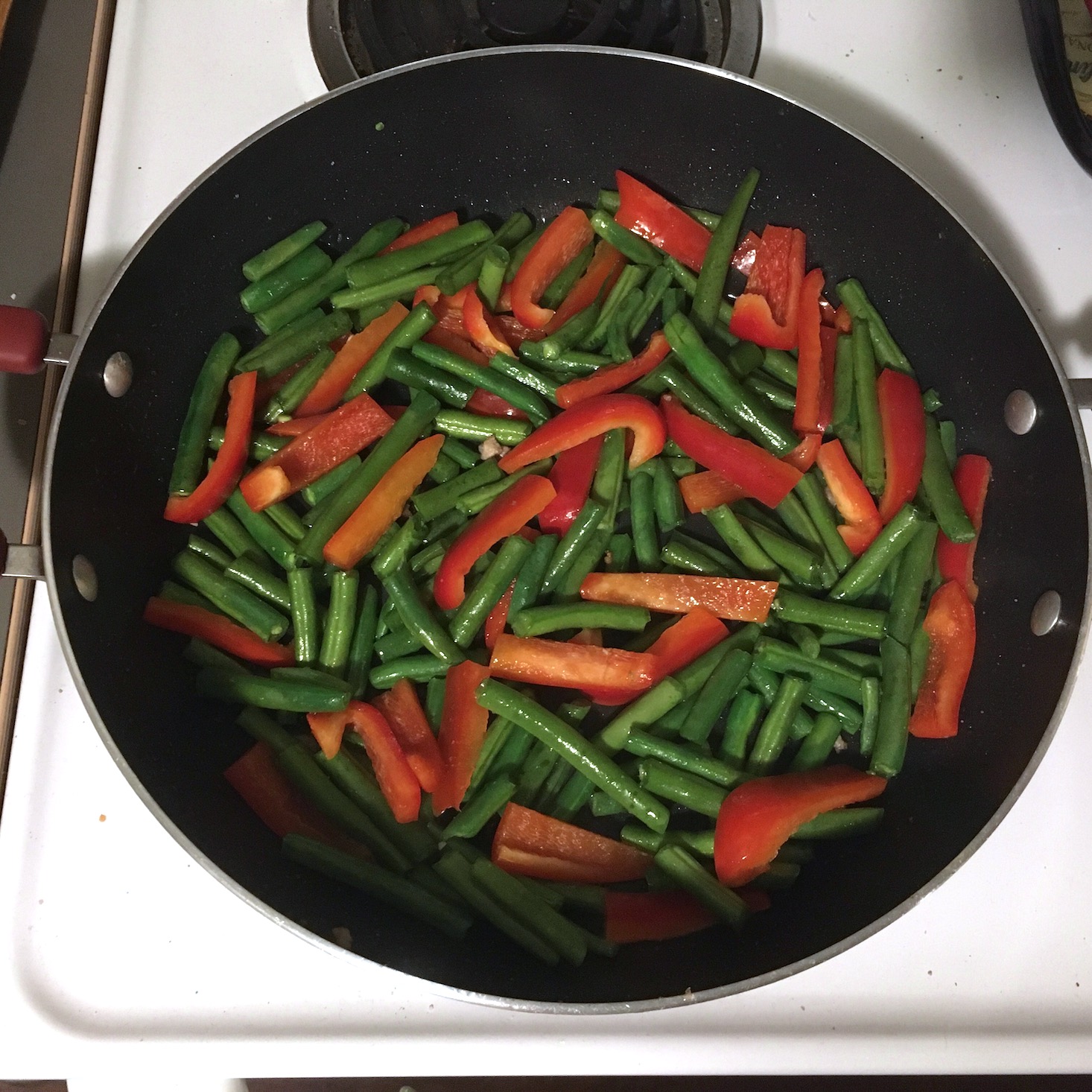 korean pork noodles veggies cooking in pan