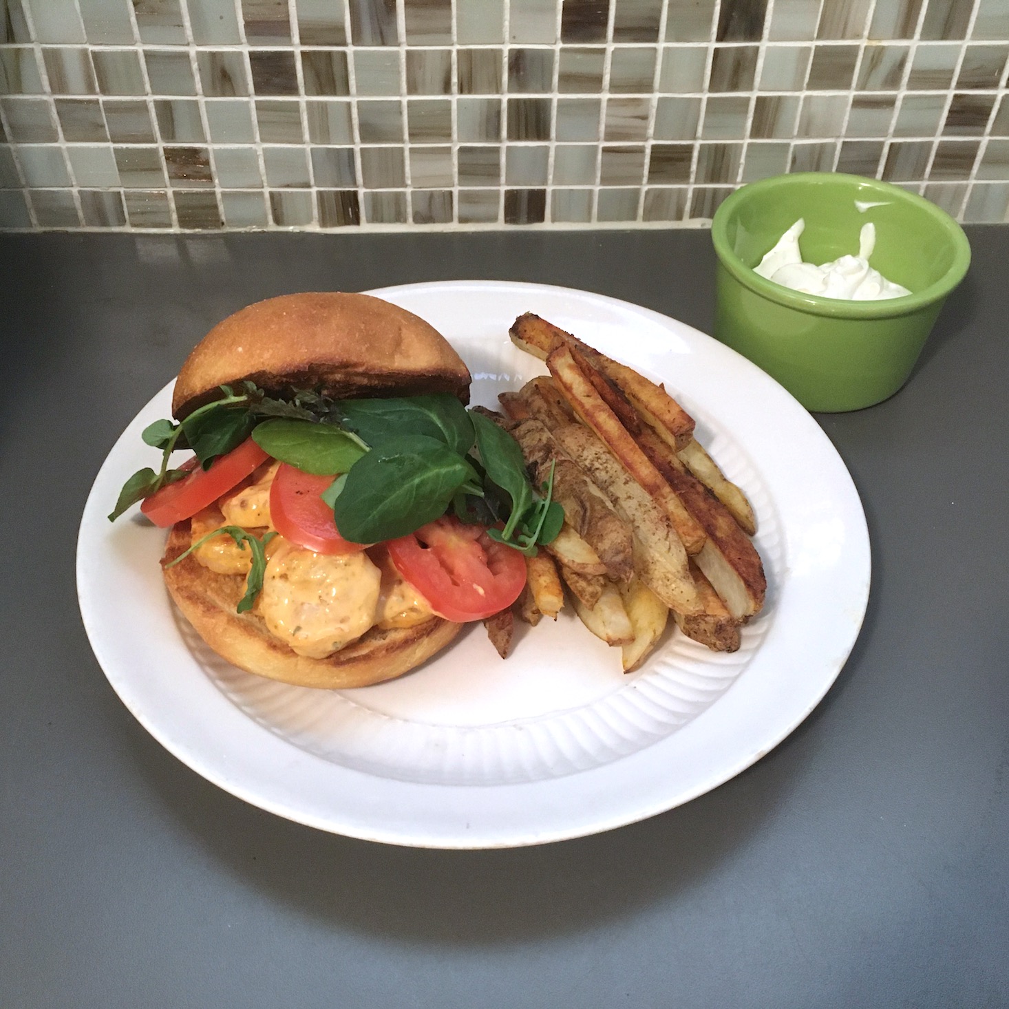 shrimp sandwich plated with tile backdrop