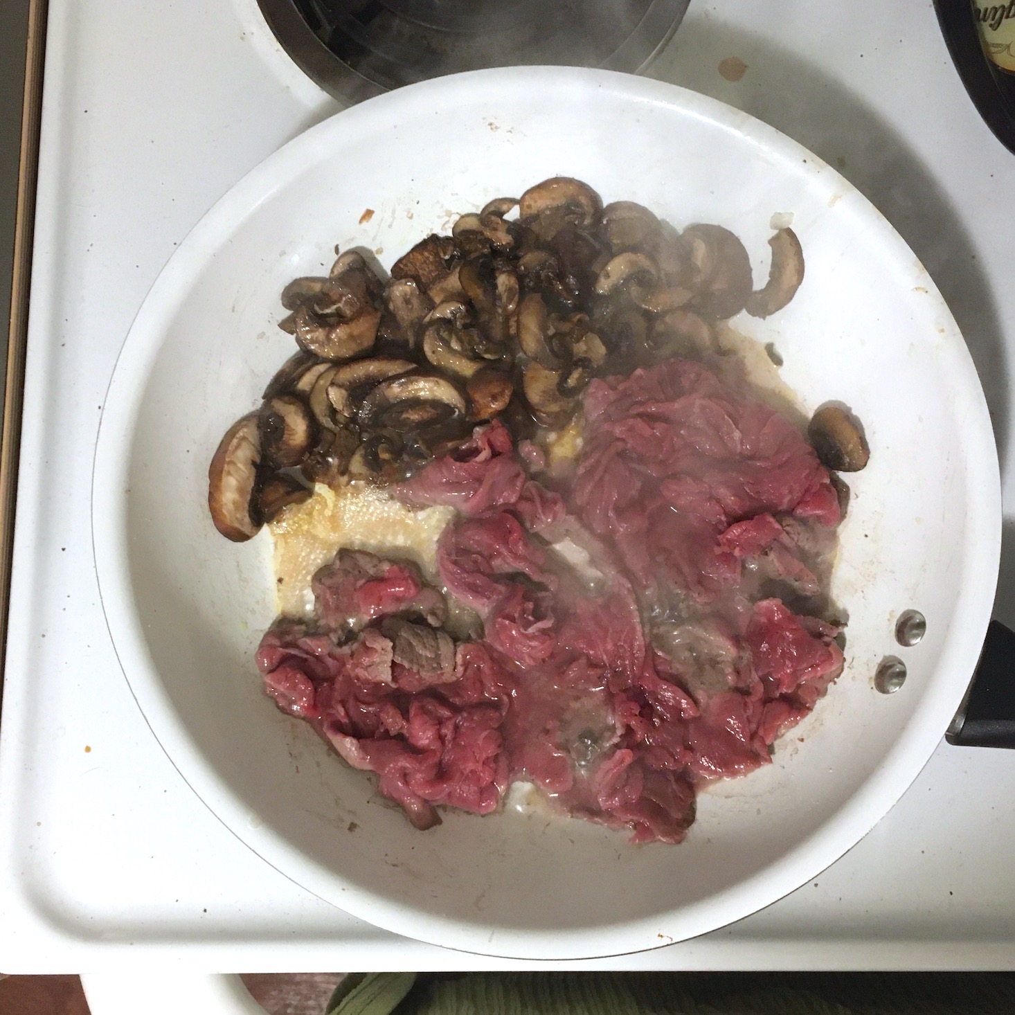 steak risotto mushrooms and steak cooking in pan