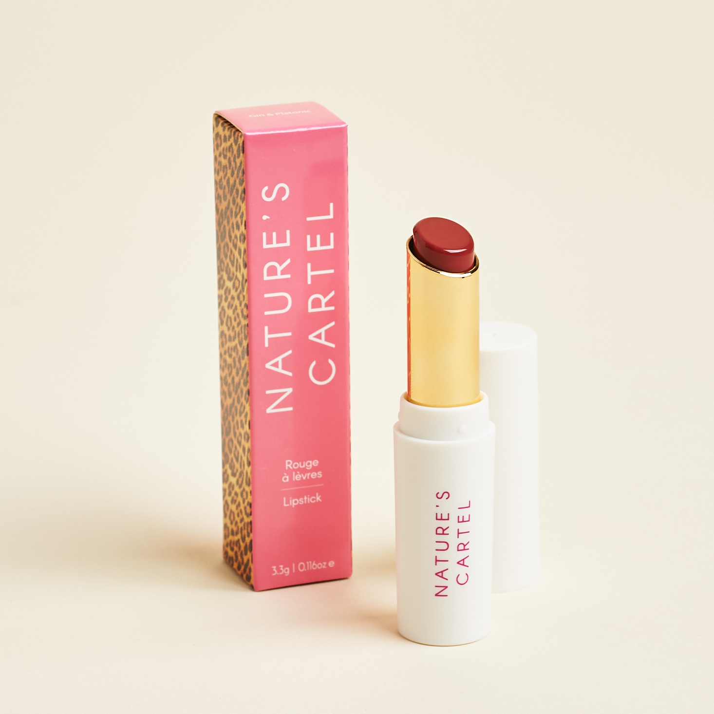 white lipstick tube with gold interior and reddish lip color