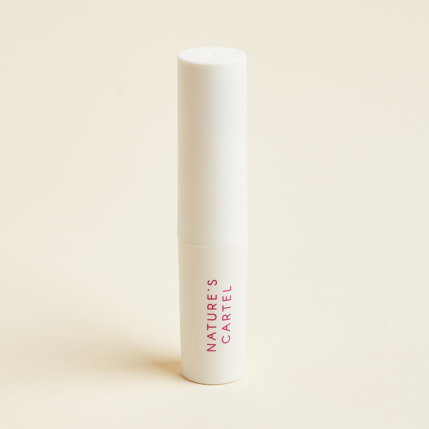 white tube of lipstick with pink text