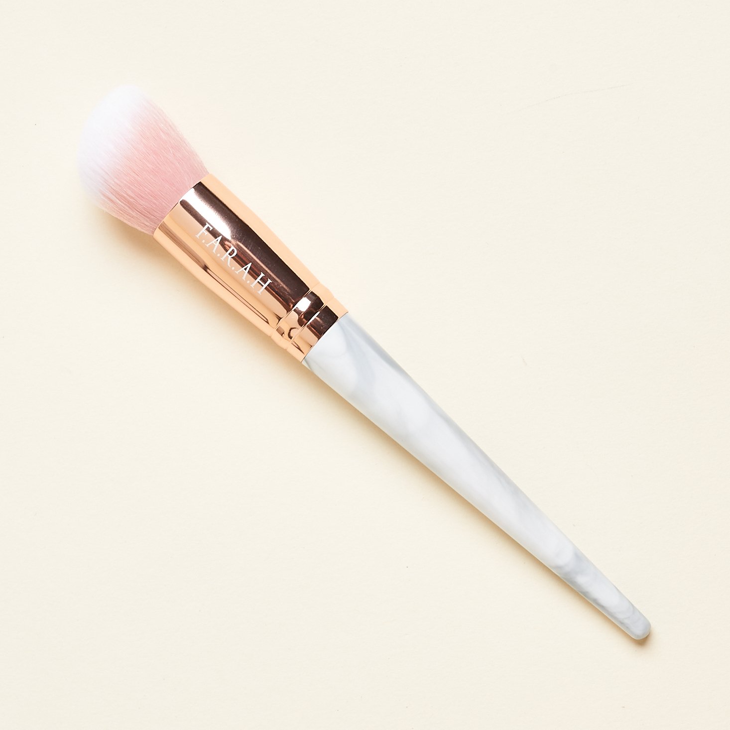 marble handled brush with blush and white bristles