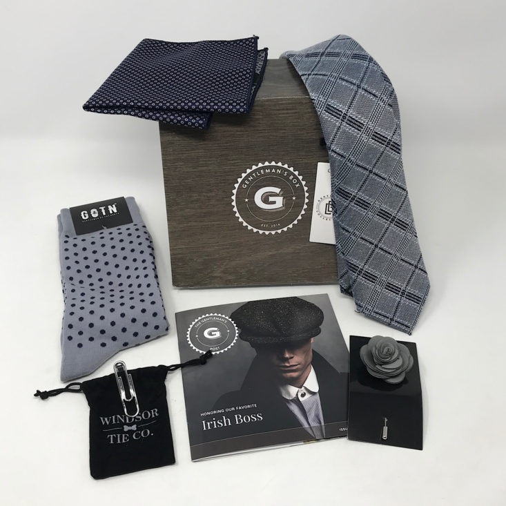 Gentleman's Box subscription with grey and black socks, tie, pocket square, and other men's accessories.