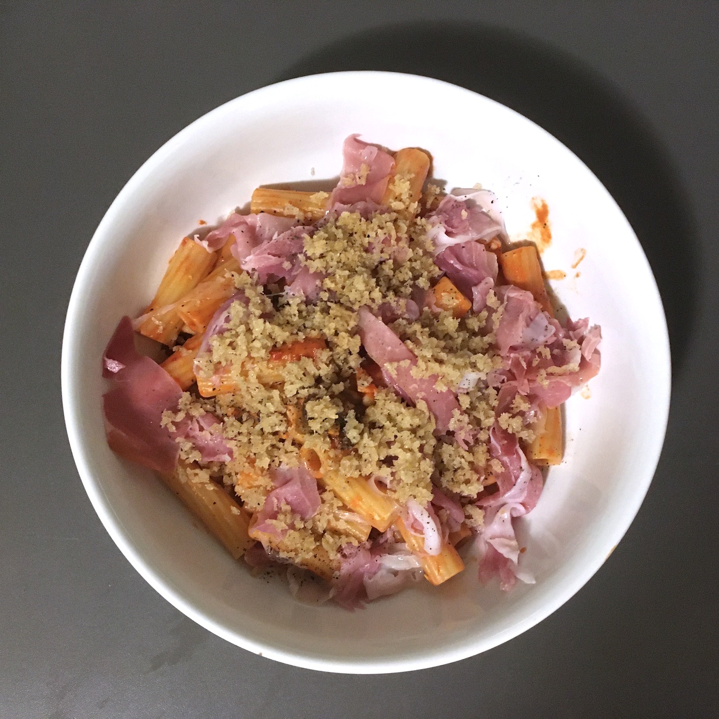 Blue Apron February 2020 - prosciutto and tomato pasta noodles added to pan plated top view