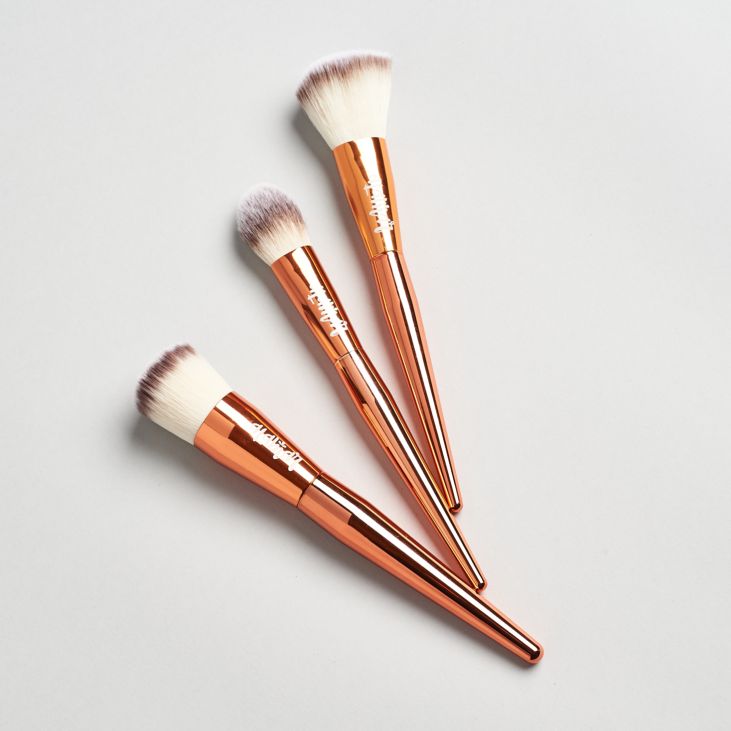 trip of rose gold brushes with white bristles
