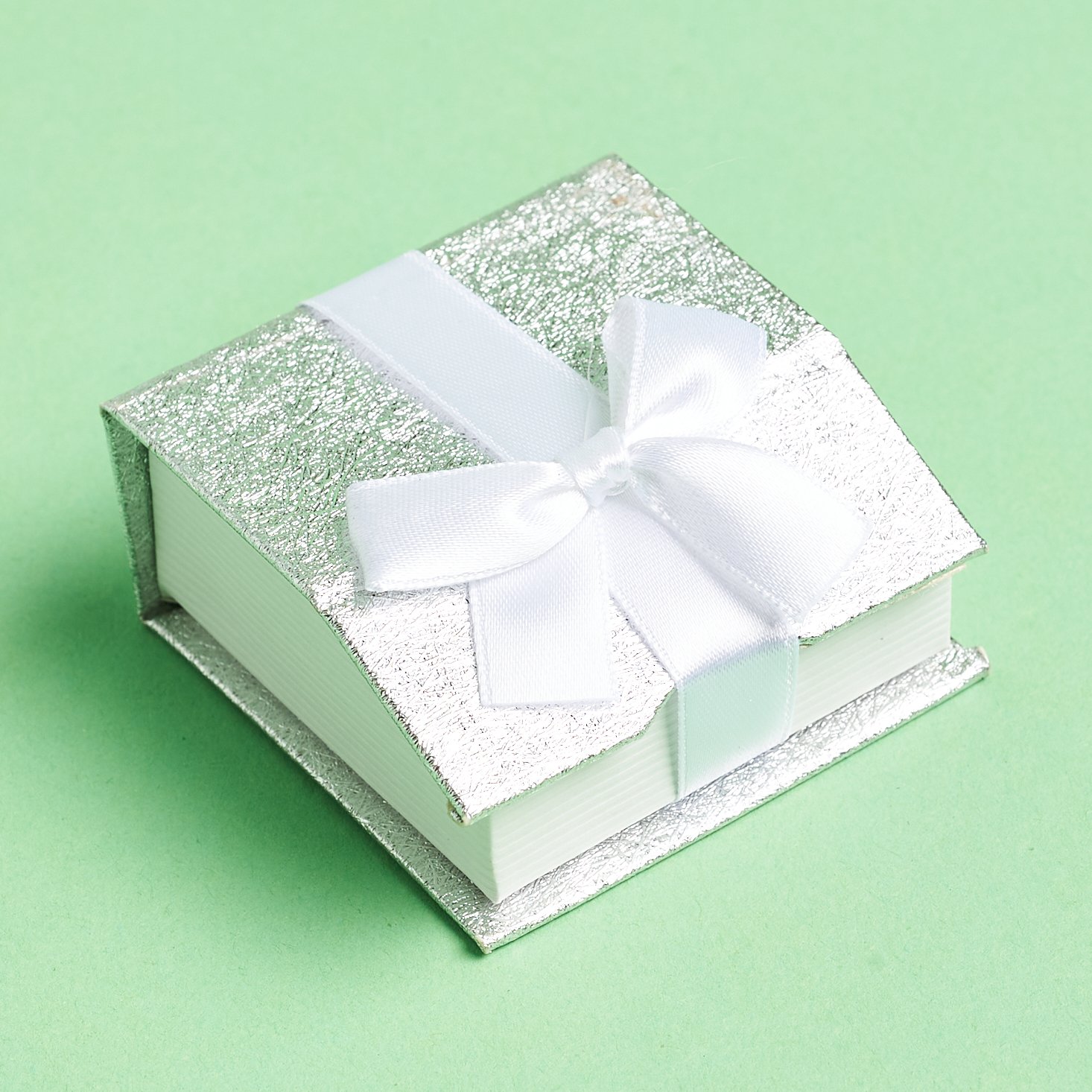 silver jewelry box with white bow