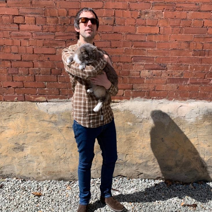 Kurt in frank and oak clothing holding cat