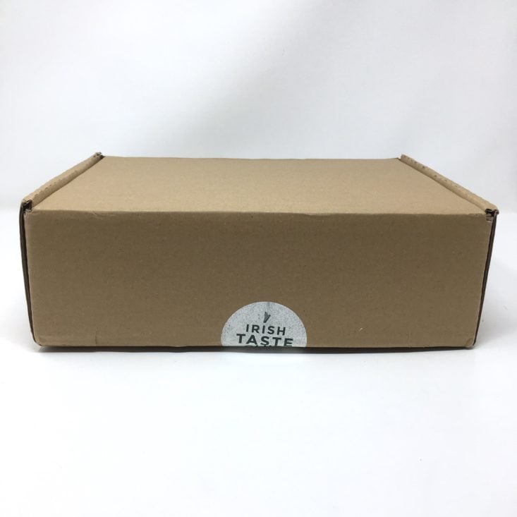 unopened box showing irish taste club sticker along seam for closure