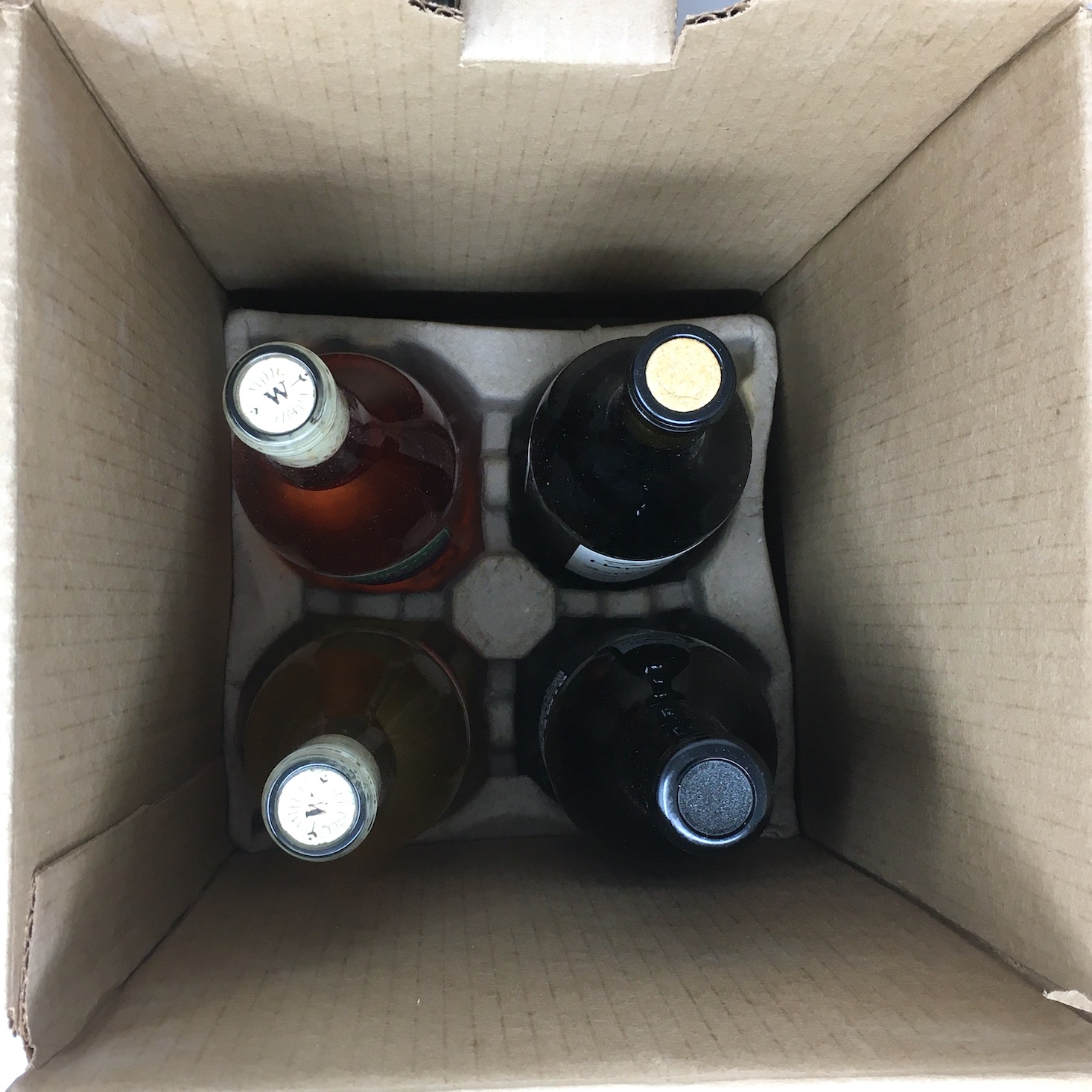 inside of box showing four upright bottles