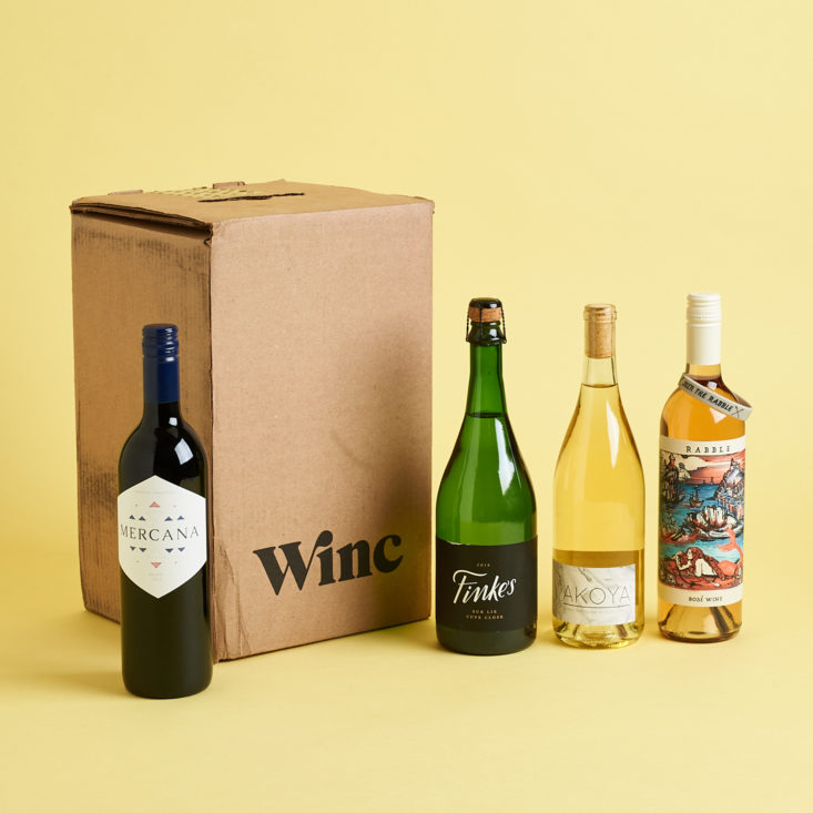 one bottle of wine to the left of the box with four bottles to the right