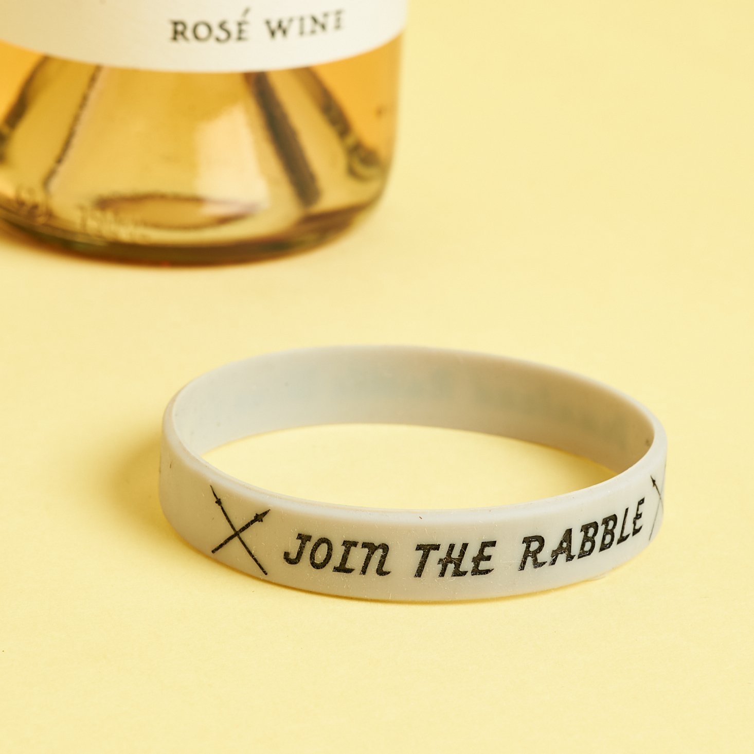 rabble rosé included rubber bracelet that says join the rabble